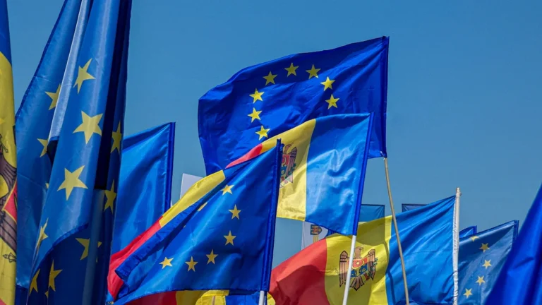 Moldovas un Eiropas Savienības karogi plīvo pasākumā Kišiņevā, simbolizējot valsts eirointegrācijas centienus.